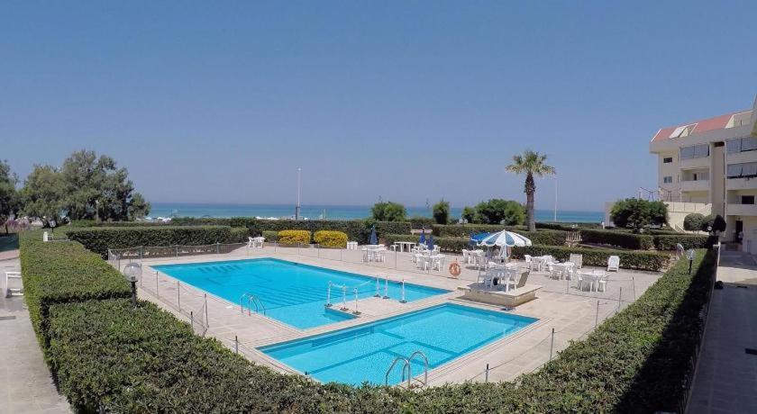 a large swimming pool next to a building at Zibibbo Beach Apartments - Trapani in Trapani