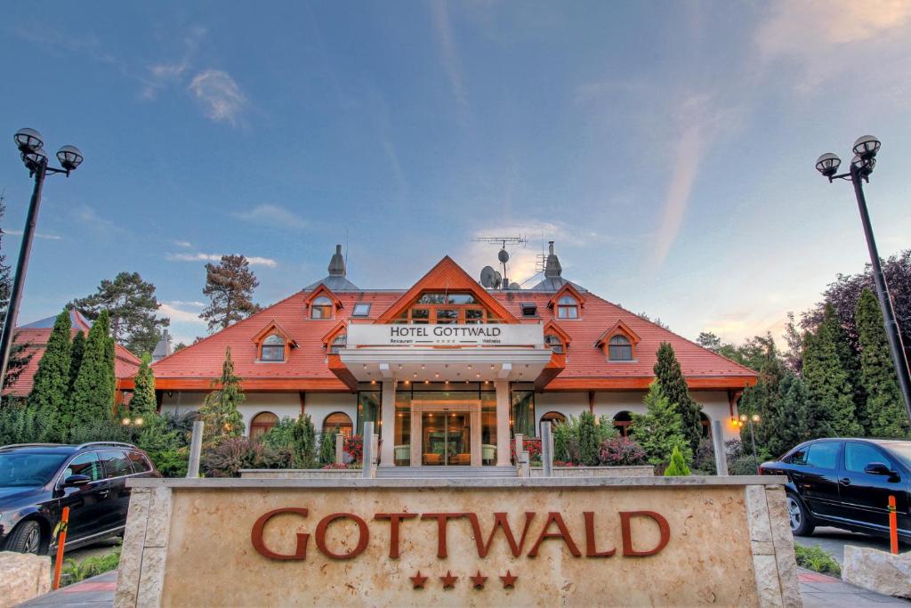 a gottwald inn sign in front of a building at Hotel Gottwald in Tata