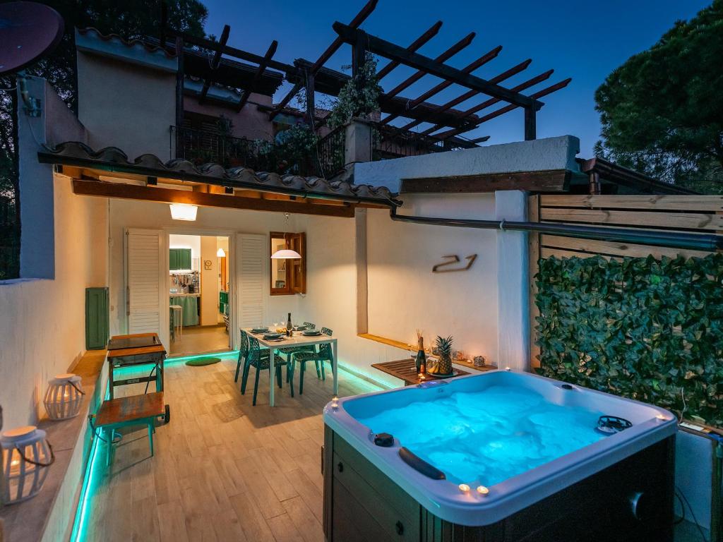 a backyard with a swimming pool and a hot tub at Sardinia SPA Apartment in Geremèas