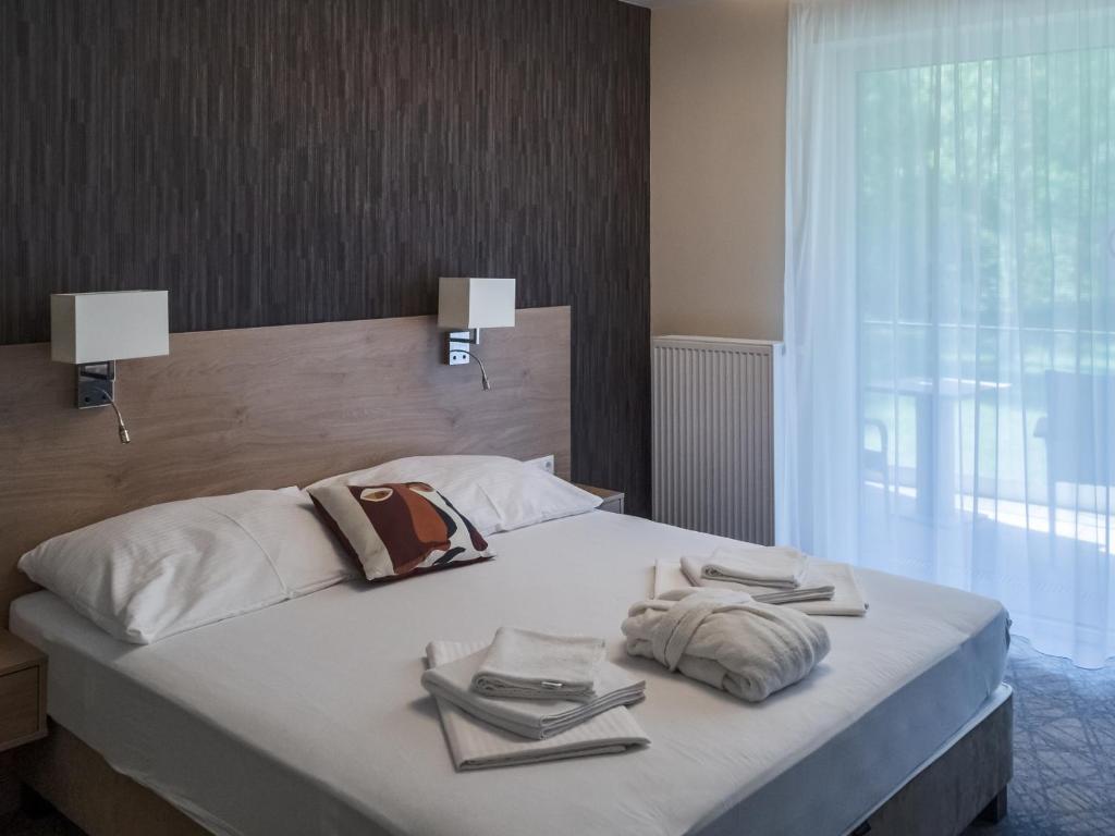 Postel nebo postele na pokoji v ubytování Easy Suites Hévíz