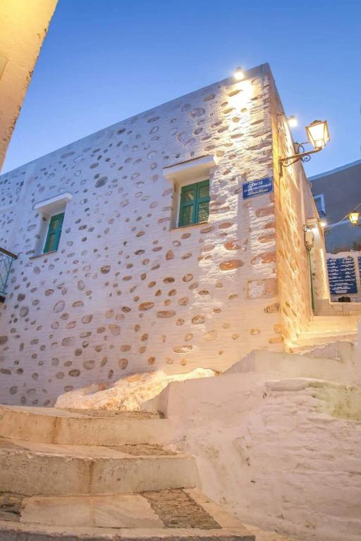 a stone building with stairs in front of it at Azura, traditional residence in Ano Syros in Ano Syros