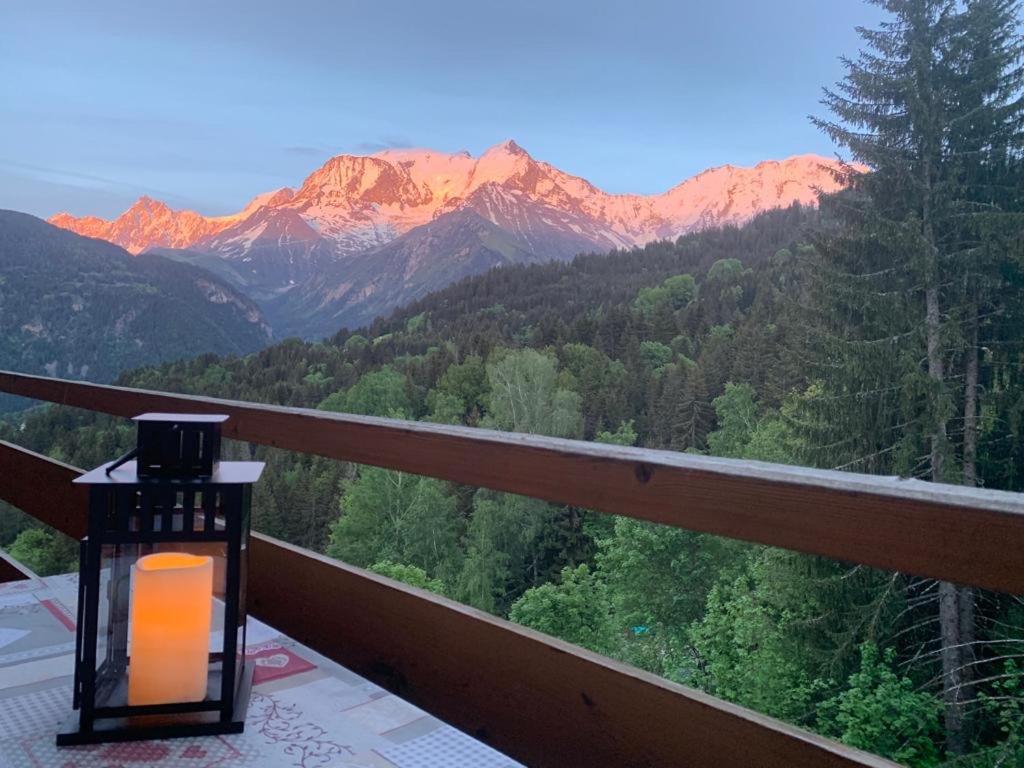 a lantern on a balcony with a view of mountains at Studio Turquoise quartier Grattague vue MontBlanc in Saint-Gervais-les-Bains