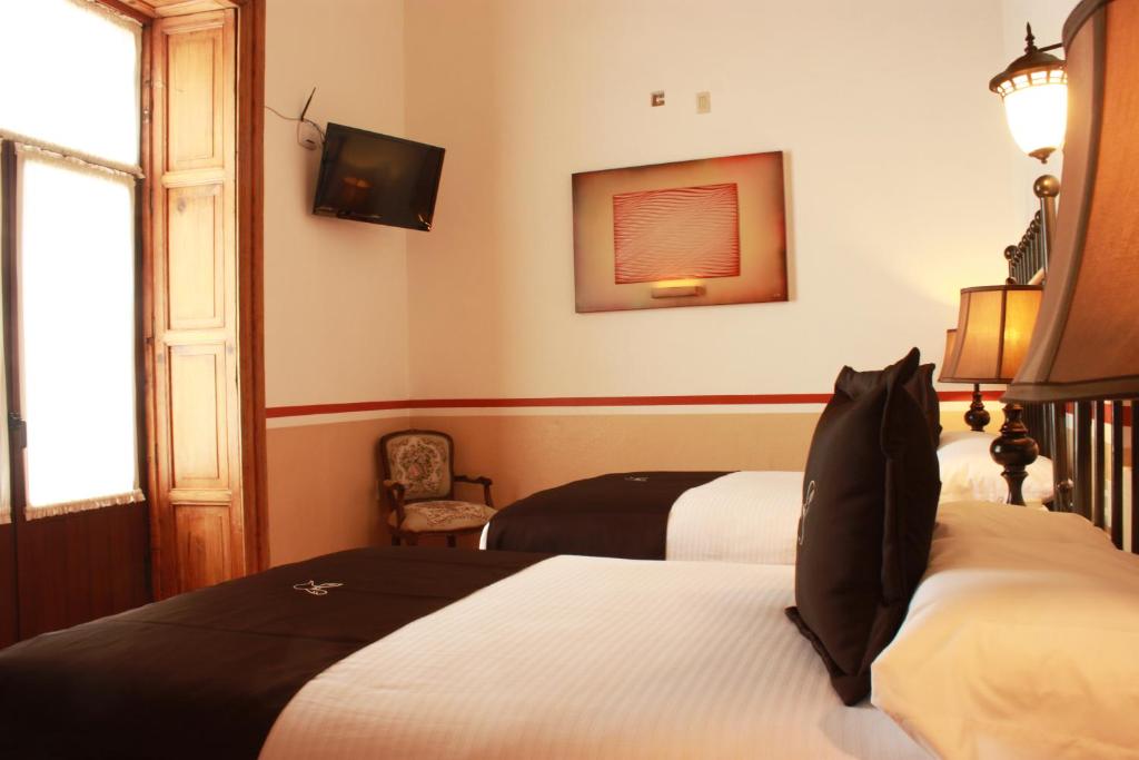 Postel nebo postele na pokoji v ubytování Hotel de la Paz