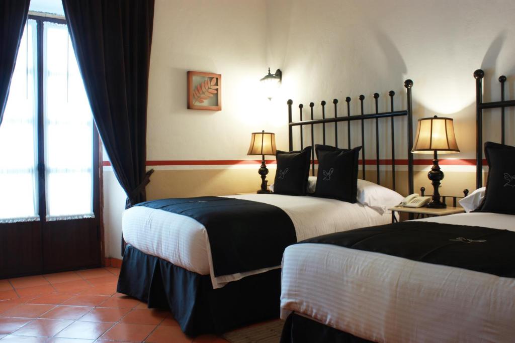 Postel nebo postele na pokoji v ubytování Hotel de la Paz