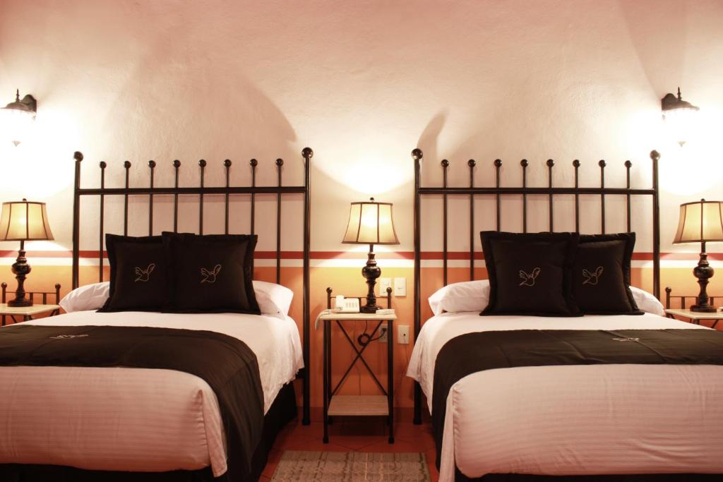 Postel nebo postele na pokoji v ubytování Hotel de la Paz
