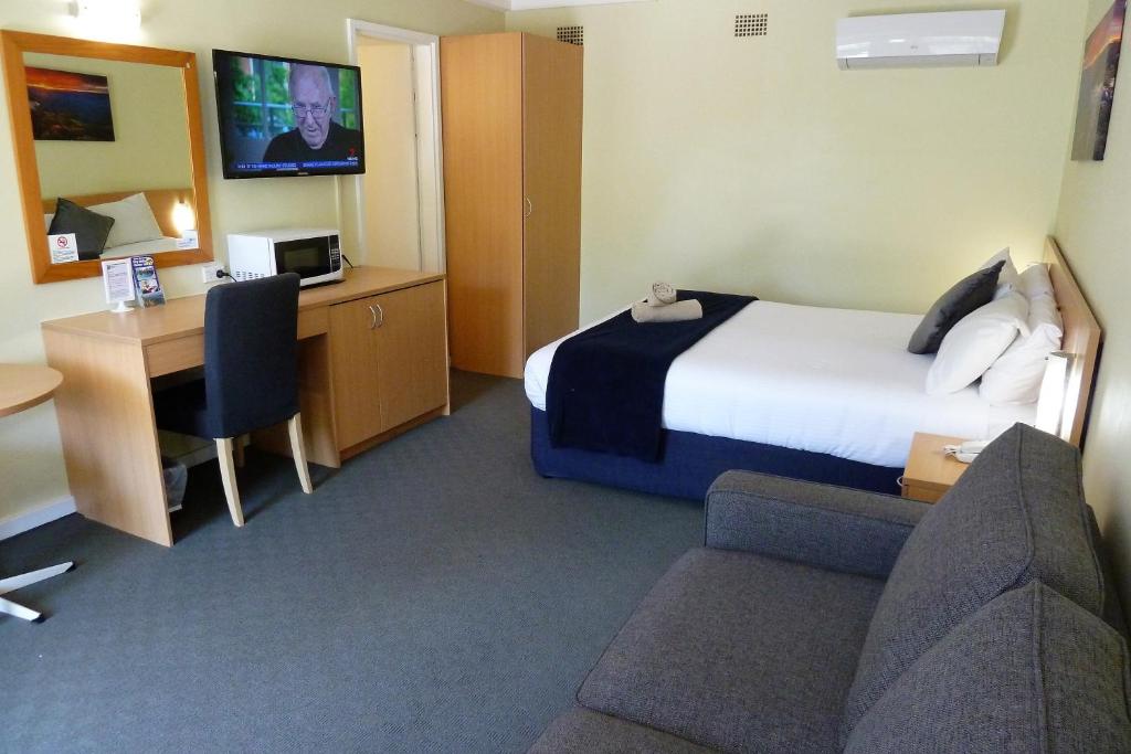 Postel nebo postele na pokoji v ubytování Sky Rider Motor Inn