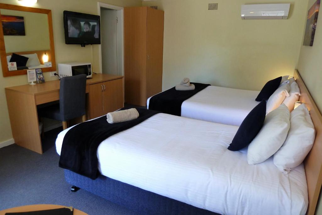 Postel nebo postele na pokoji v ubytování Sky Rider Motor Inn