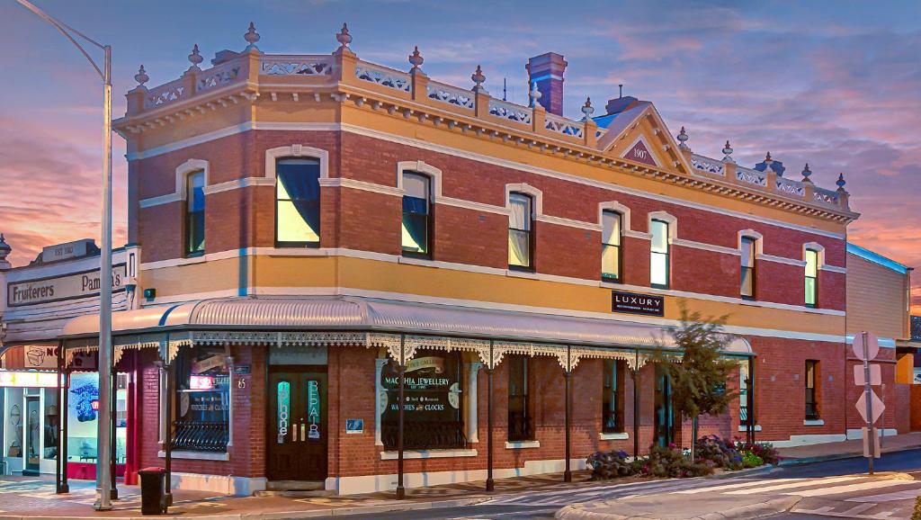 a large red brick building on a city street at Langsford Luxury in Stawell