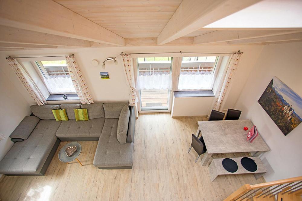 a large living room with a couch and a table at Ferienwohnung Allgäu-Füssen Landblick in Füssen