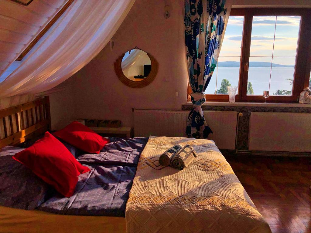 a bedroom with two beds and a mirror at Villa Borostyán in Tihany