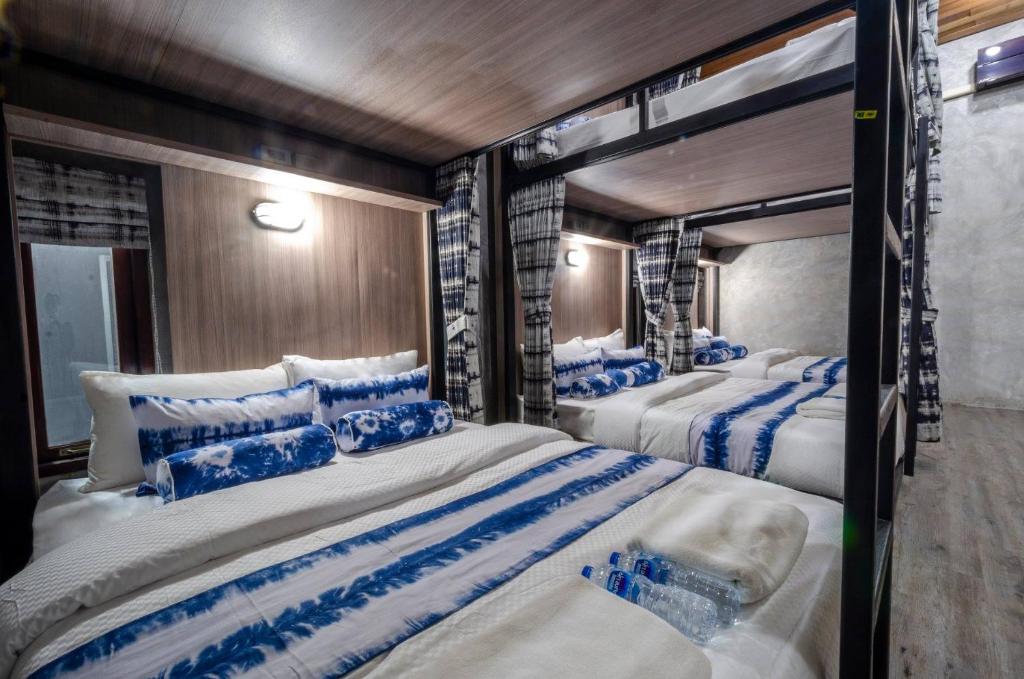 two beds in a room with blue and white at The Chic Lipe in Ko Lipe