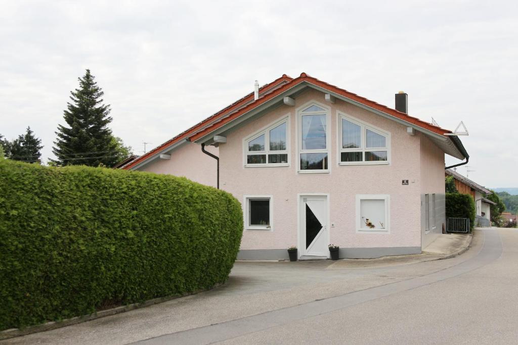 a white house with a red roof at Ferienwohnung Wandl in Bad Griesbach