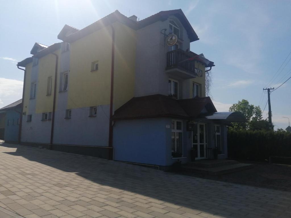 a building with a clock on the side of it at Penzión Nezábudka in Stropkov