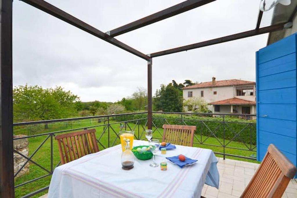 a table with a white table cloth on a balcony at Charming apartment in Zambratija, 44 sqm, Parking included in Zambratija