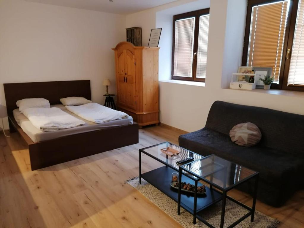 a living room with a bed and a couch at Apartment Dubnica Prejta in Dubnica nad Váhom