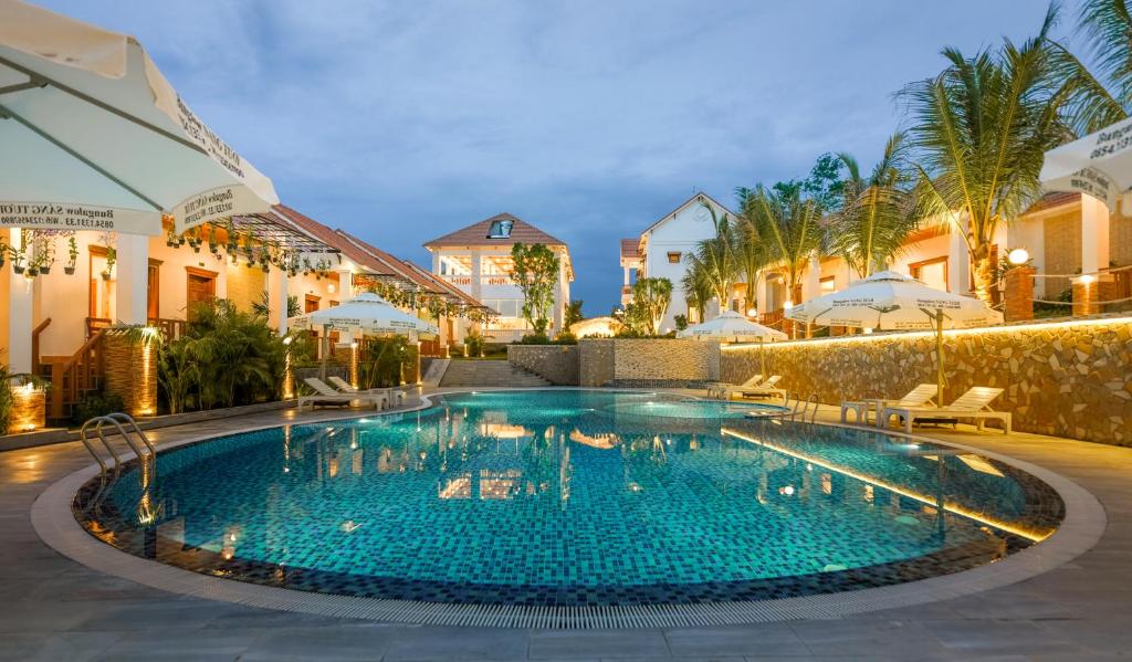 a swimming pool in a resort at night at Bungalow Sáng Tươi Mountains in Phu Quoc