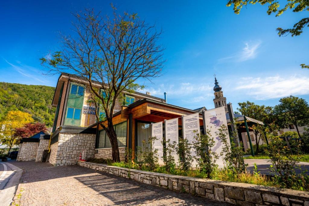 a building with a clock tower in the background at Hotel Diana in Valdobbiadene