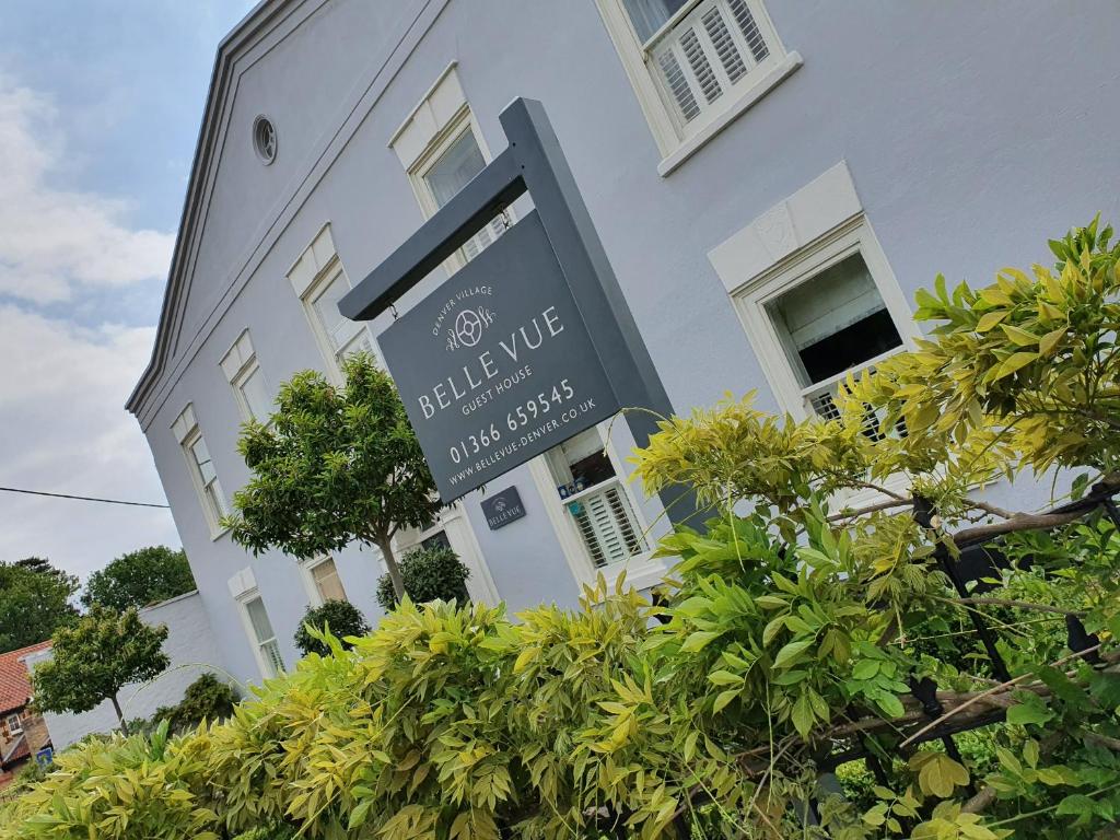 a white building with a sign in front of it at Belle Vue Guest House in Denver