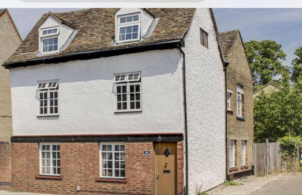 a white house with a brown roof at The Old Rose And Crown - St Neots in Saint Neots