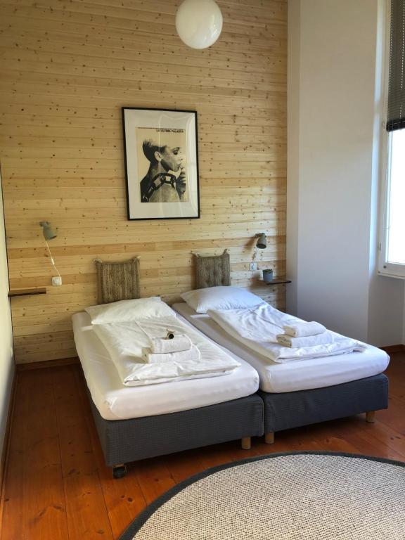 a bed in a room with a wooden wall at berlincity in Berlin