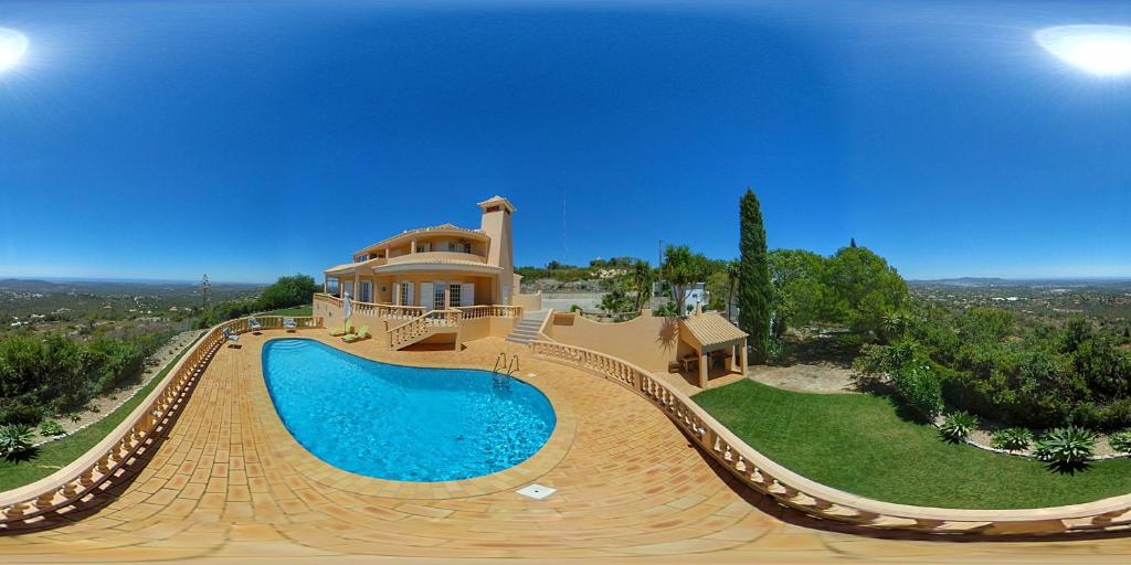a house with a swimming pool in front of a house at Elegant family house in Loulé with private pool in Loulé