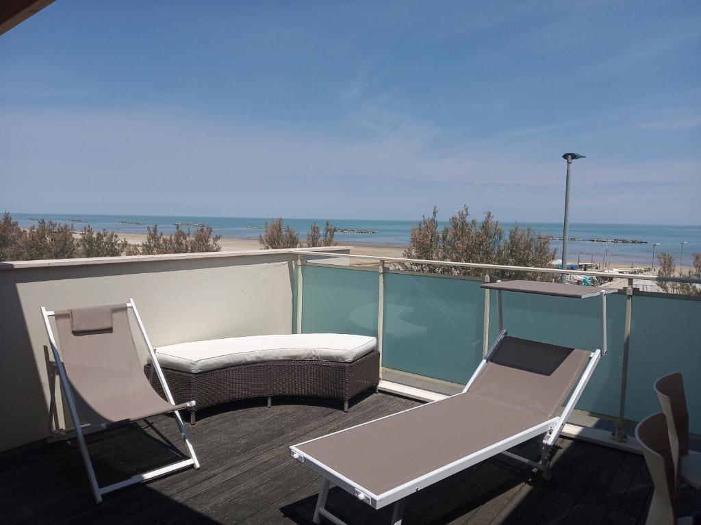 d'un balcon avec deux chaises et un canapé, ainsi que de la plage. dans l'établissement villa a mare, à Senigallia