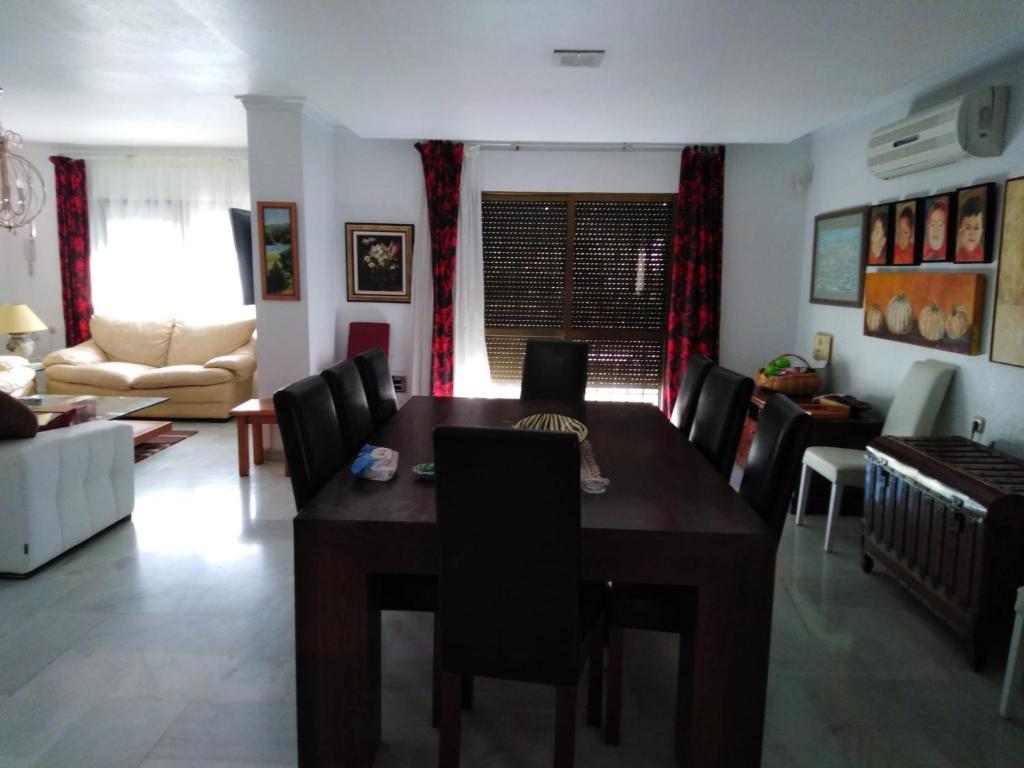 sala de estar con mesa de madera y sillas en Casa Marin, en Esparragalico