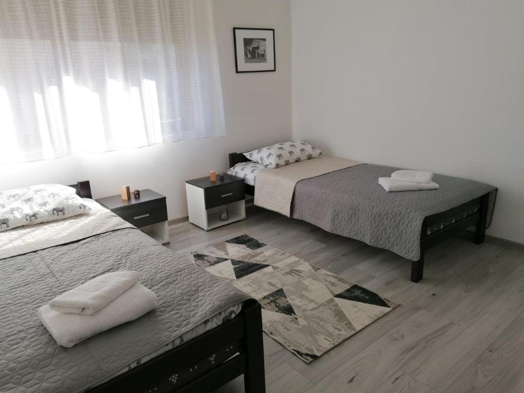 Postel nebo postele na pokoji v ubytování Apartman Santos