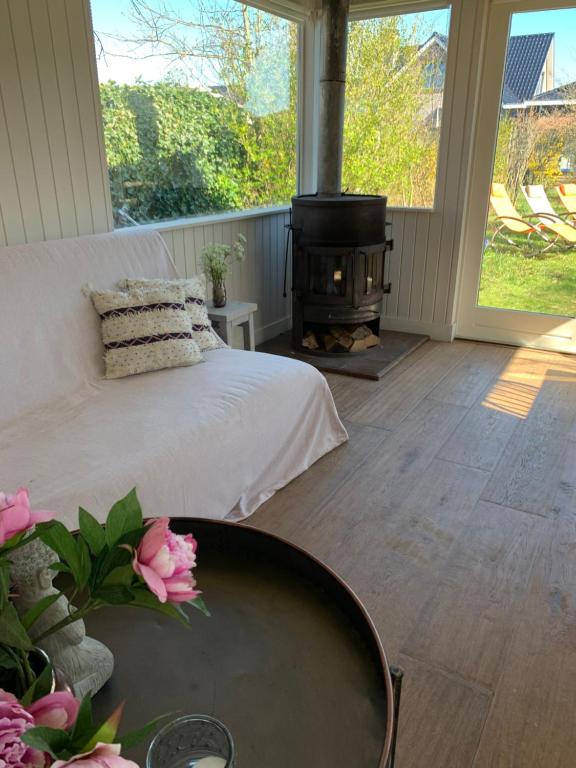 a bedroom with a bed and a fire pit at Het Schulpje in Egmond-Binnen