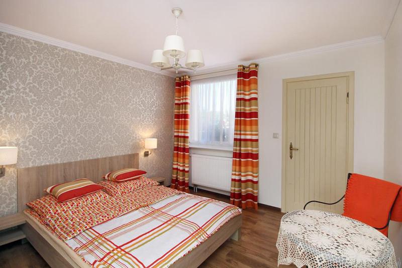Postel nebo postele na pokoji v ubytování Manifik Pokoje Gościnne