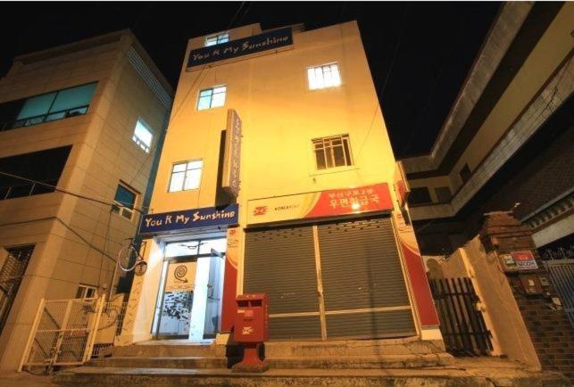 a large building with a door on the side of it at Yusun Guesthouse in Busan