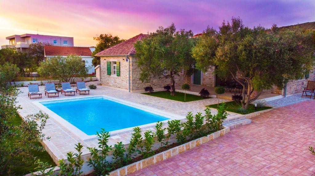 a swimming pool in the backyard of a house at Vacation Home Mate Ceko in Sukošan