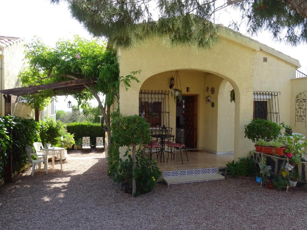 a house with a patio with a table and chairs at Casa Mediterráneo in La Marina