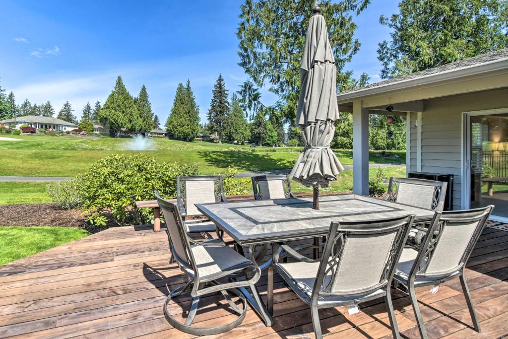 a patio with a table with an umbrella at Spacious Family Home on Golf Course Hike and Bike! in Bremerton