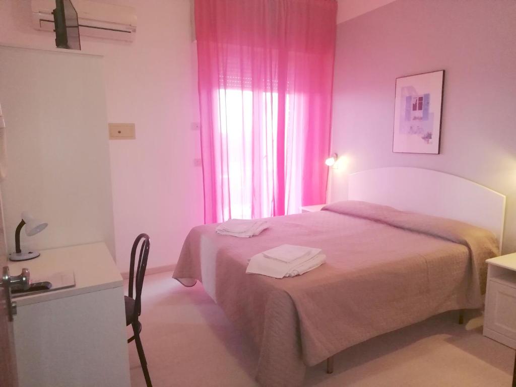 Postel nebo postele na pokoji v ubytování Hotel Rita