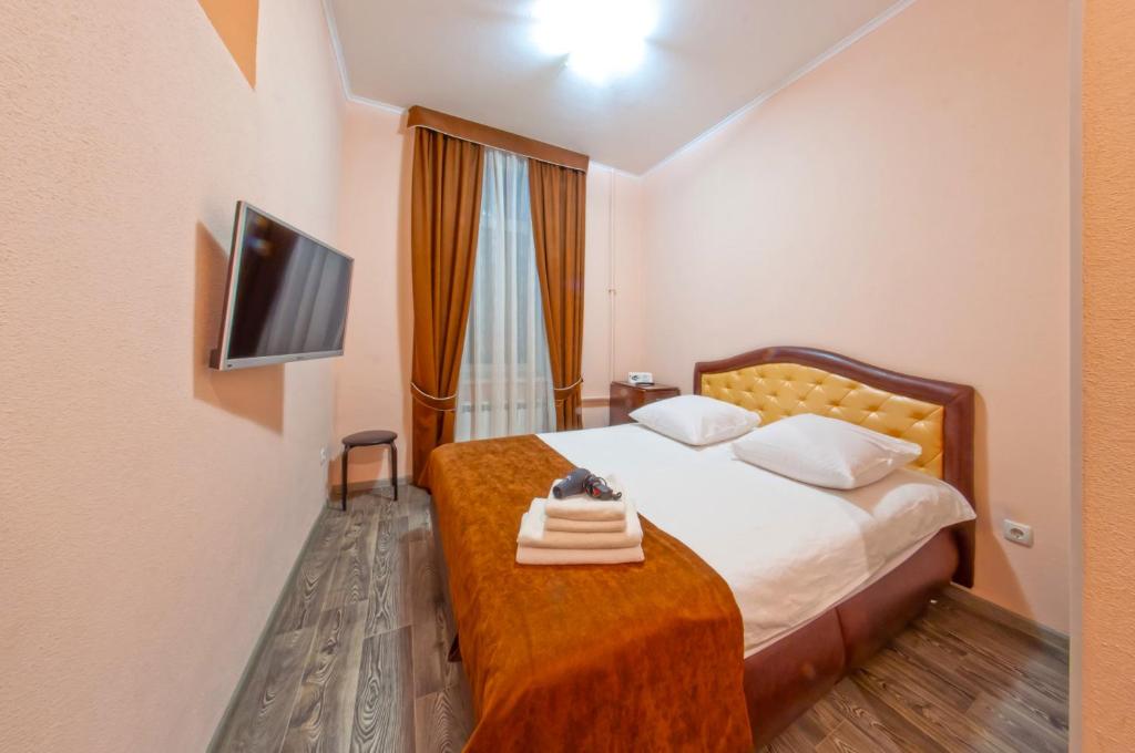 a hotel room with a bed and a television at Seven in Vyshneve