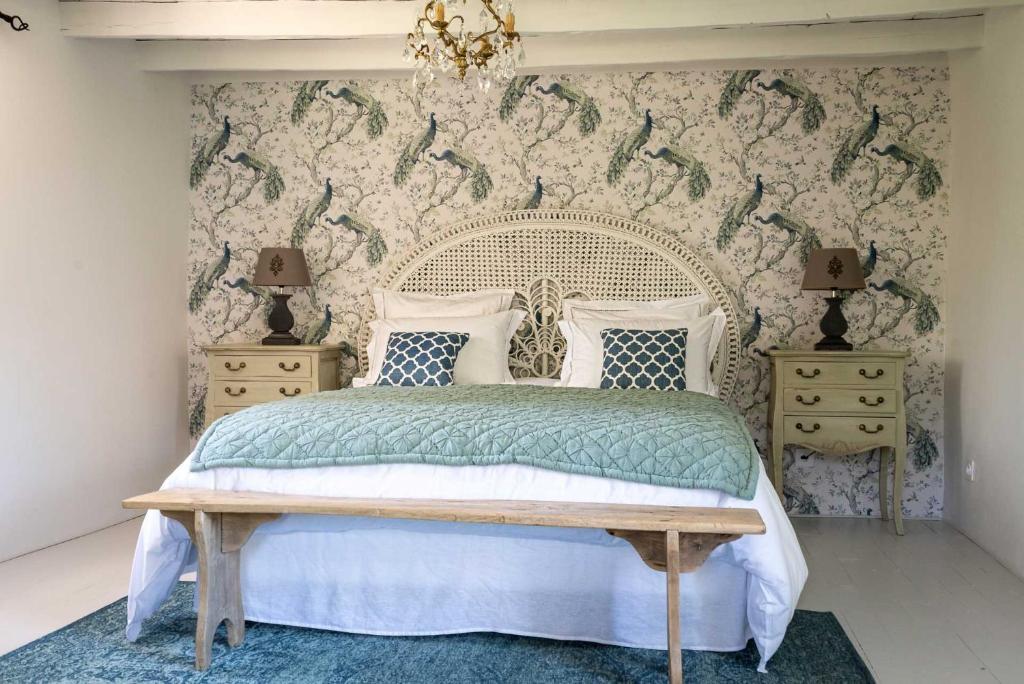 ein Schlafzimmer mit einem weißen Bett und zwei Nachttischen in der Unterkunft au Mas de Garet - Chambre d'hotes de Charme in Pinsac