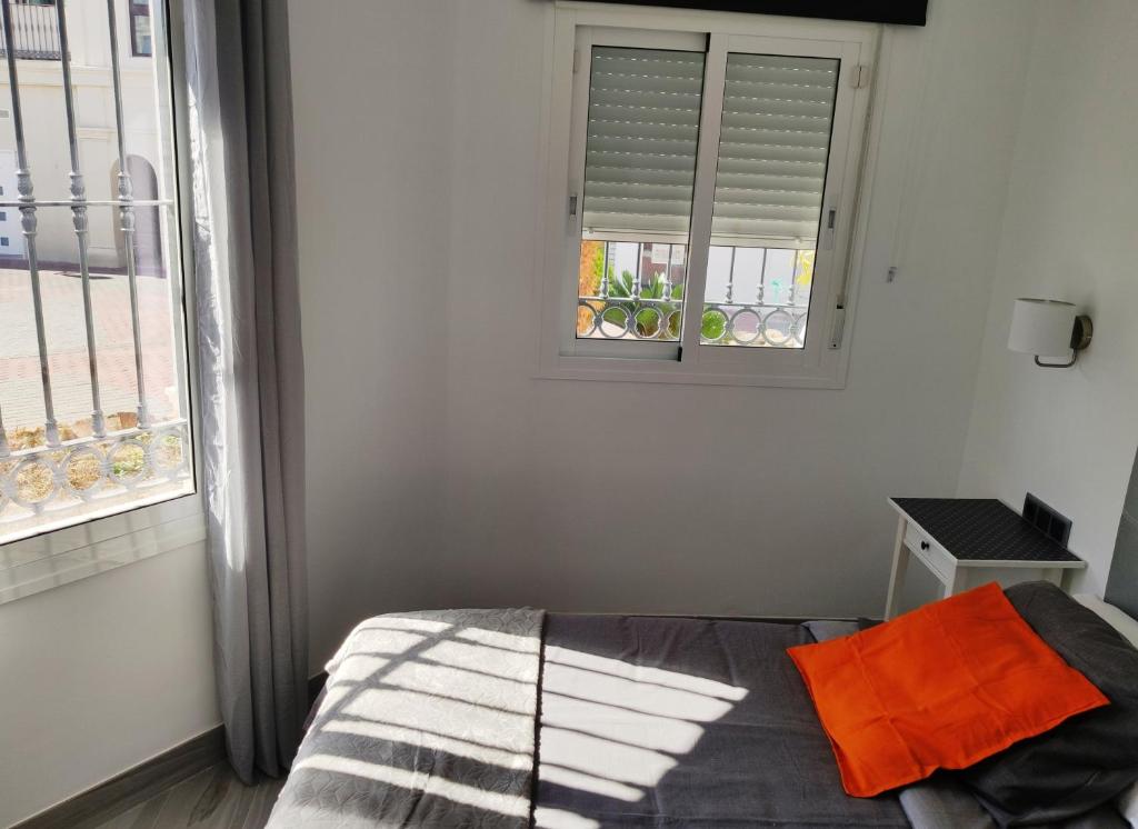 A bed or beds in a room at Apartamentos Gran Plaza De Nerja
