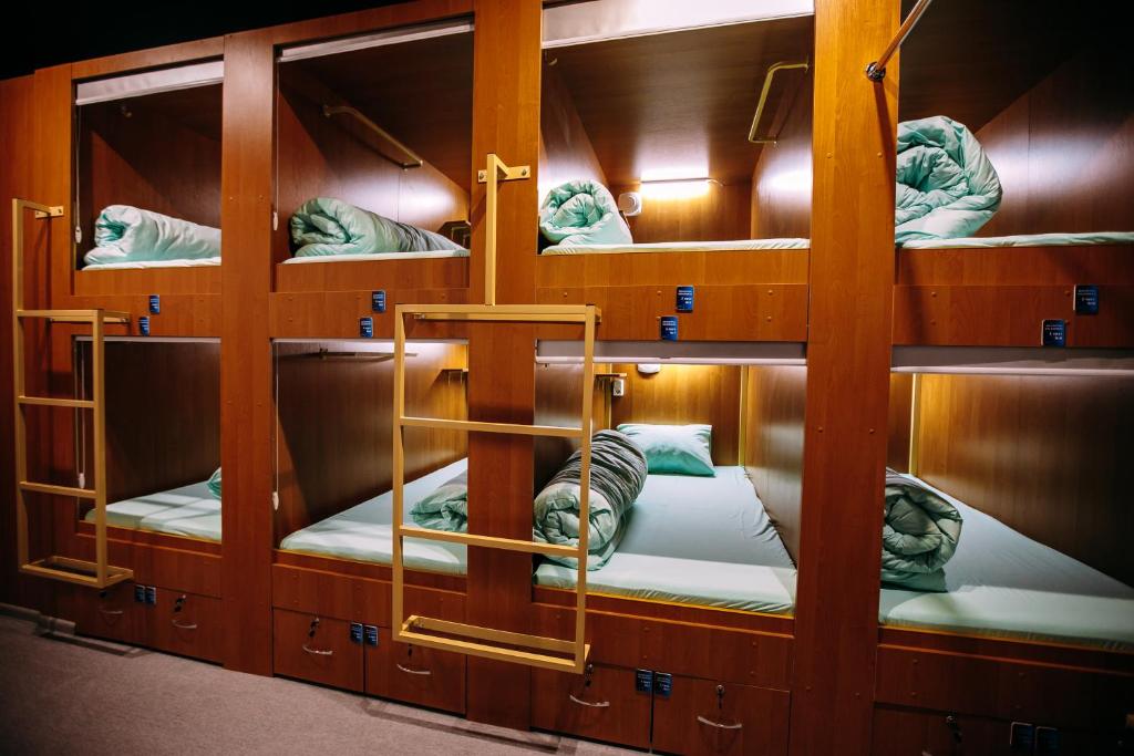 a group of bunk beds in a room at Kapsula vremeni Сapsule hotel in Volgograd