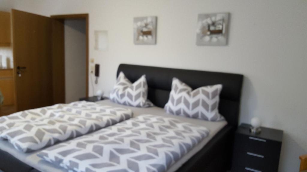 a bedroom with a large bed with pillows on it at FERIEN APPARTMENTS in Pirmasens