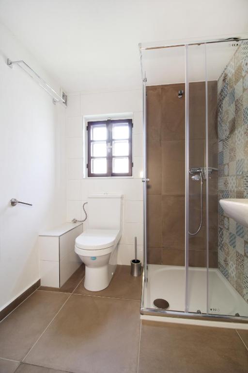 a bathroom with a toilet and a glass shower at Pension Adel in Český Krumlov