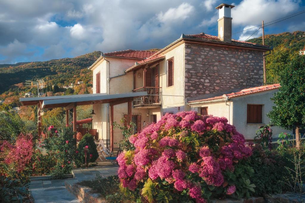 a house with pink flowers in front of it at Villa Marina, Βίλλα Μαρίνα in Mileai