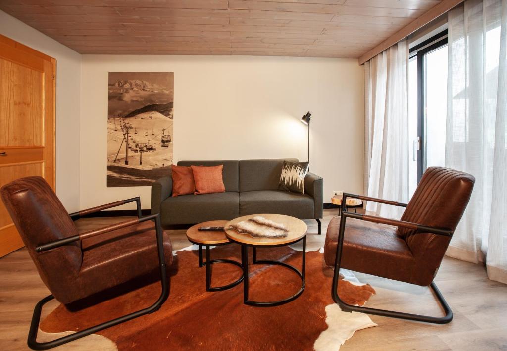a living room with a couch and chairs and a table at Haus 4 Montafon by Pferd auf Wolke in Gaschurn