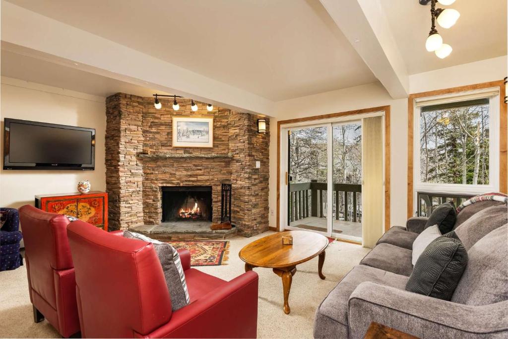 a living room with a couch and a fireplace at Interlude 103 in Snowmass Village