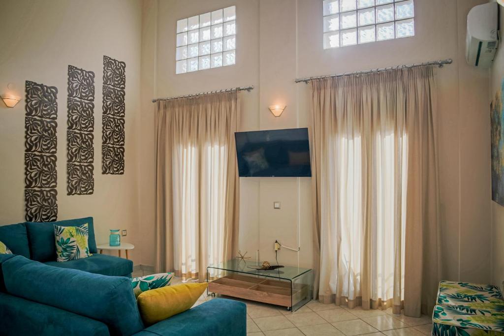 a living room with a couch and a tv at San Marco Luxury Apartment Zante in Zakynthos Town