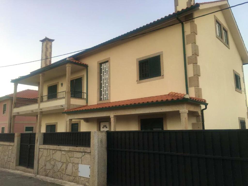 a large house with a black fence in front of it at 9 bedrooms villa with private pool jacuzzi and enclosed garden at Ponte de Lima Viana do Castelo in Ponte de Lima