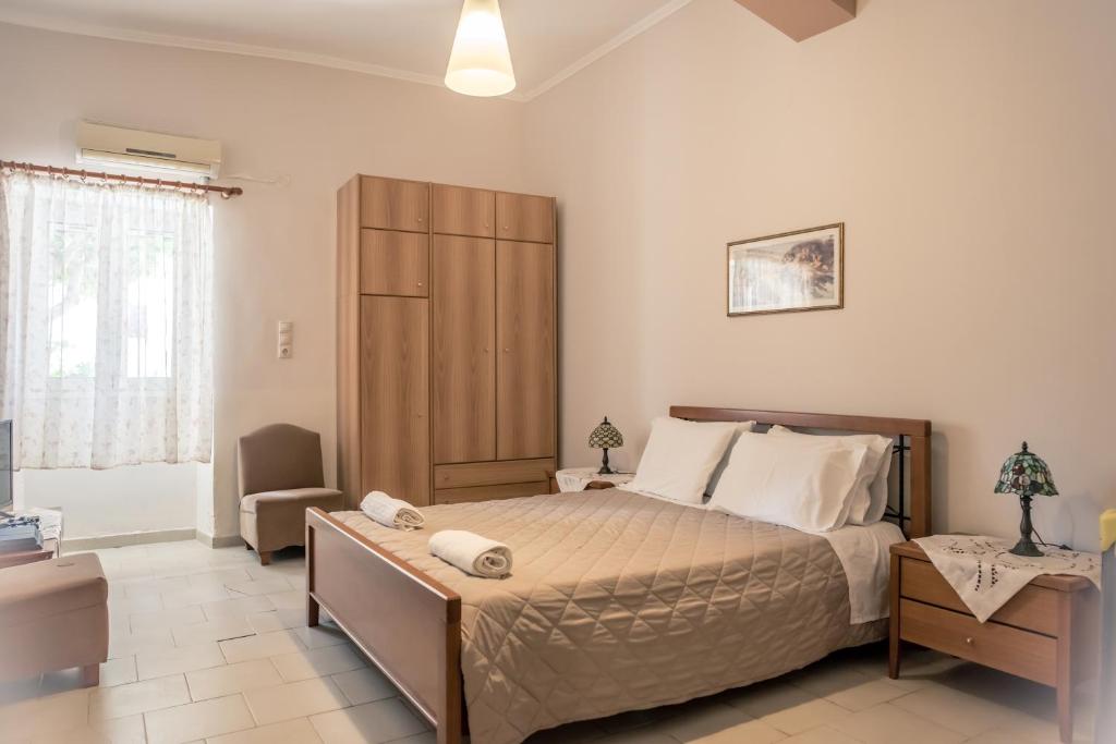 a bedroom with a large bed and a large window at Konstantina's Fairytale House in Kissamos