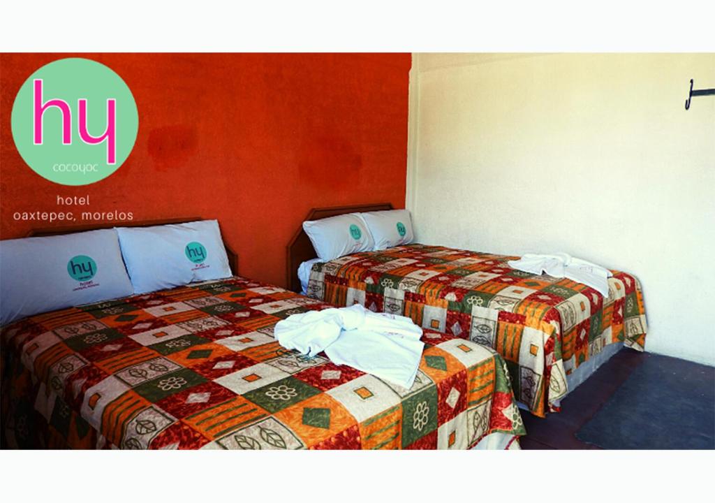 two beds sitting next to each other in a room at Hy Cocoyoc in Oaxtepec