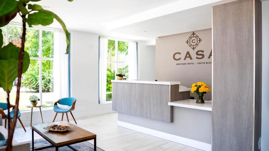 a lobby with a casa sign on the wall at Casa Boutique Hotel in Miami Beach