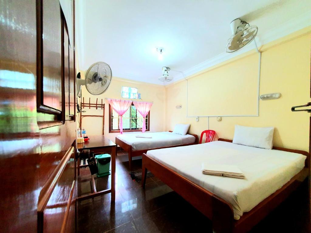 Postel nebo postele na pokoji v ubytování Visal Sak Guesthouse